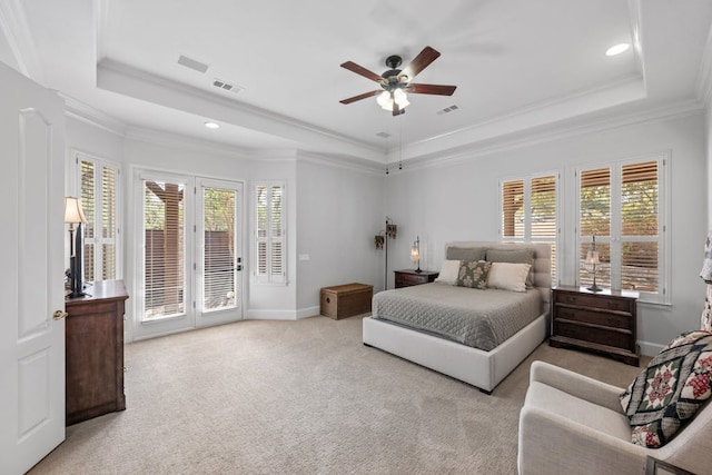 bedroom featuring access to exterior, visible vents, a tray ceiling, and light colored carpet