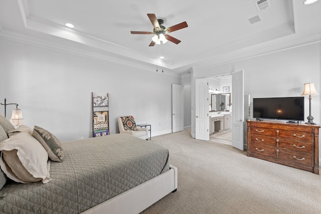 bedroom featuring visible vents, a tray ceiling, ornamental molding, and light colored carpet