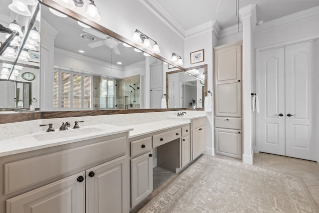 bathroom with ceiling fan, a stall shower, a sink, and crown molding