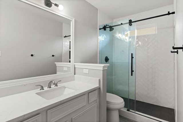 full bath with a shower stall, toilet, and vanity