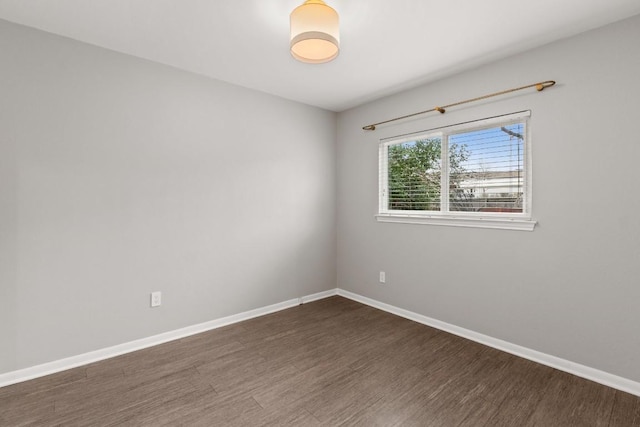 unfurnished room with wood finished floors and baseboards