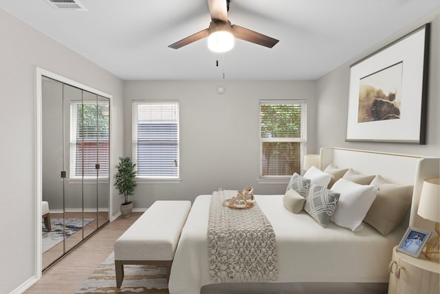 12807 Covington Trl, Austin, TX 78727 - bedroom with wood finished floors, baseboards, ceiling fan, and a closet