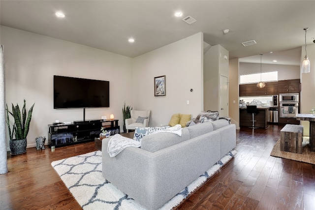 living area featuring visible vents, dark wood finished floors, and recessed lighting