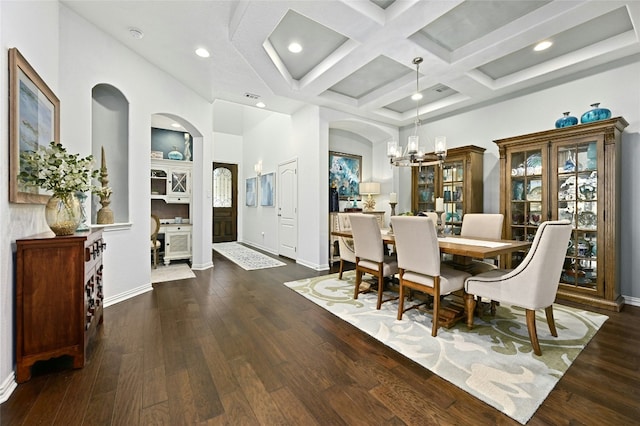 dining space with dark wood-style floors, a chandelier, coffered ceiling, and baseboards