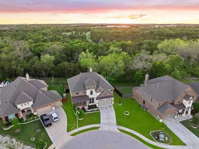 aerial view at dusk with a residential view and a forest view