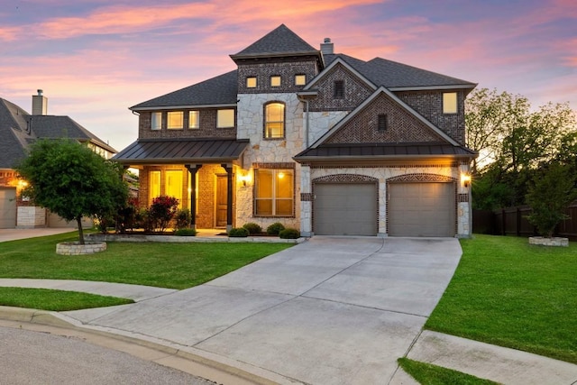 view of front facade with a standing seam roof, a lawn, concrete driveway, and metal roof