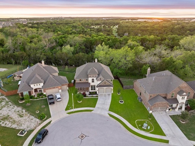 aerial view at dusk with a view of trees