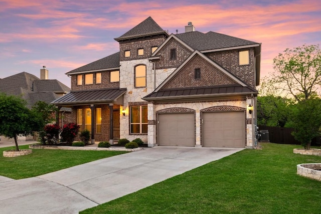 view of front of home with roof with shingles, concrete driveway, a lawn, a standing seam roof, and metal roof