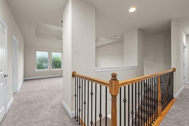 corridor featuring recessed lighting, light colored carpet, and baseboards