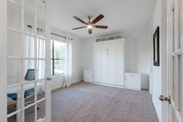 bedroom featuring light carpet, ceiling fan, and baseboards