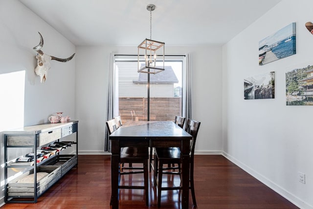 dining space with dark wood-style flooring and baseboards