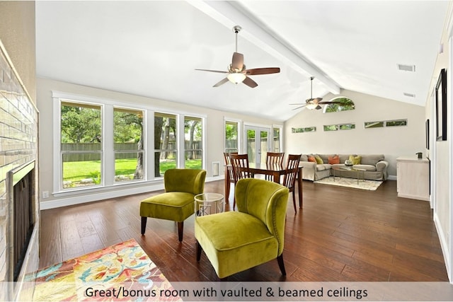 interior space featuring vaulted ceiling with beams, a fireplace, and visible vents