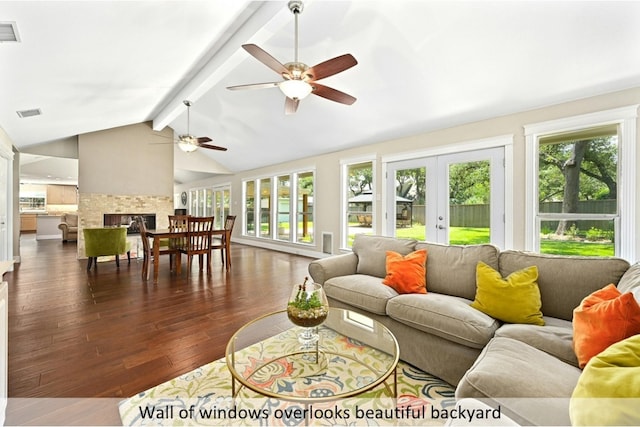 9903 Richelieu Rd, Austin, TX 78750 - living room with ceiling fan, lofted ceiling with beams, dark wood finished floors, plenty of natural light, and french doors