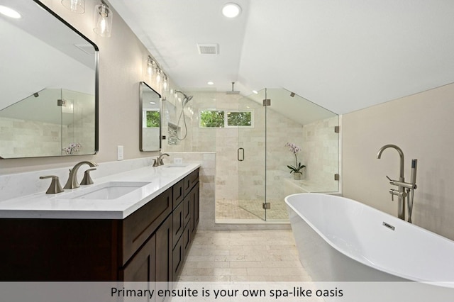 bathroom featuring a sink, a stall shower, a freestanding tub, and visible vents