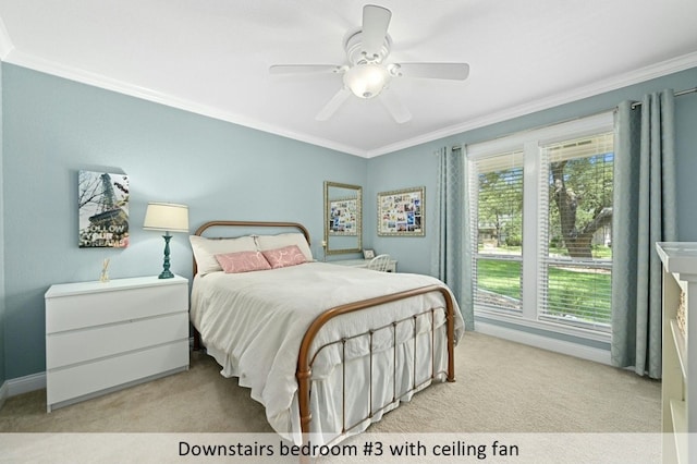 bedroom with light carpet, baseboards, a ceiling fan, and crown molding