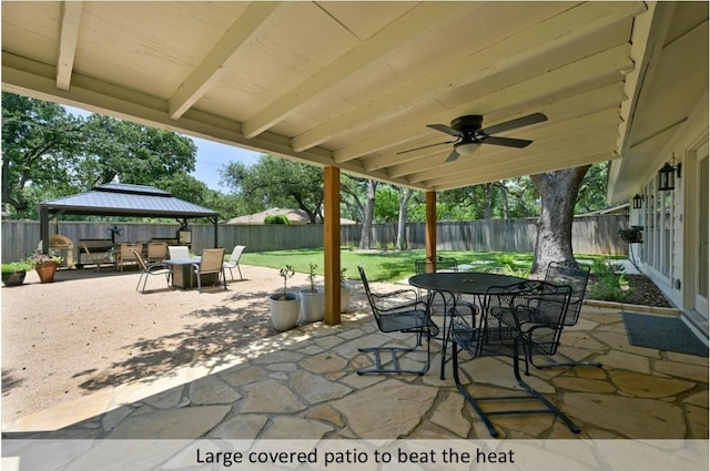 view of patio / terrace with a ceiling fan, outdoor dining space, a fenced backyard, and a gazebo