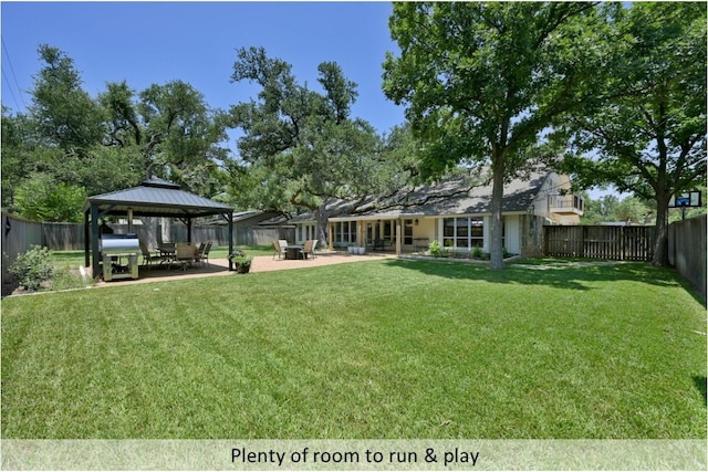 view of yard with a patio area, a fenced backyard, and a gazebo