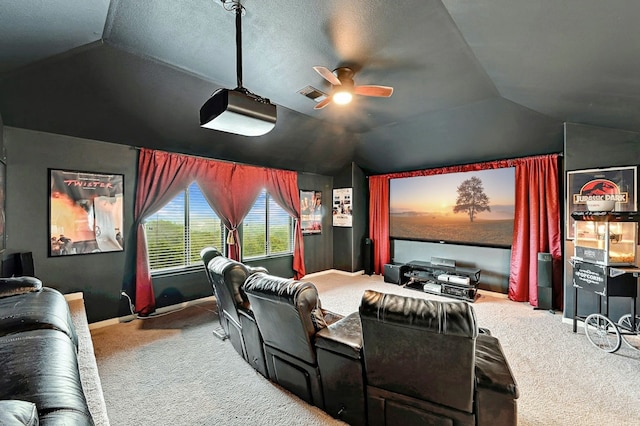 carpeted home theater with visible vents, baseboards, a ceiling fan, and vaulted ceiling