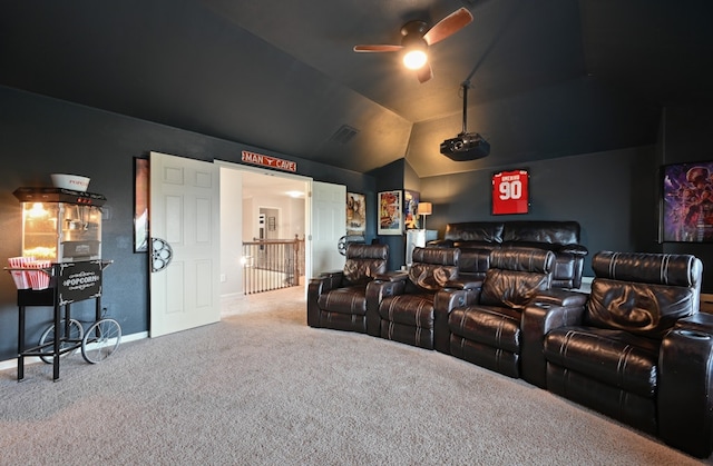 carpeted cinema room with visible vents, ceiling fan, vaulted ceiling, and baseboards