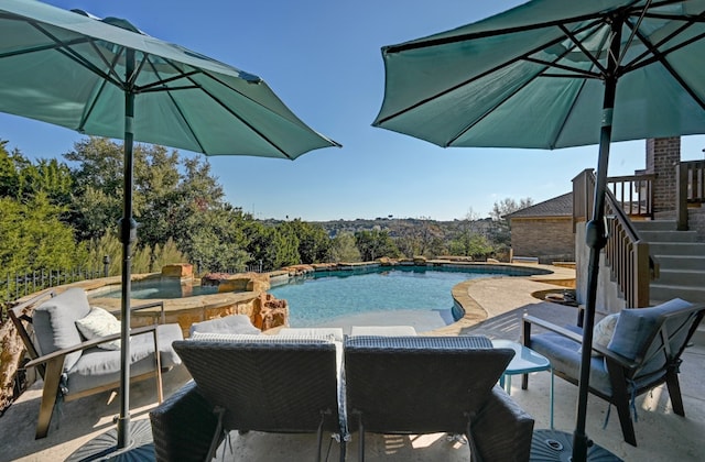 outdoor pool with a patio area and stairs