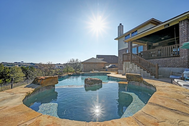 view of swimming pool with a patio area, ceiling fan, stairway, fence, and a fenced in pool