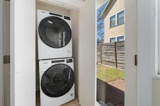 washroom featuring laundry area and stacked washer / drying machine