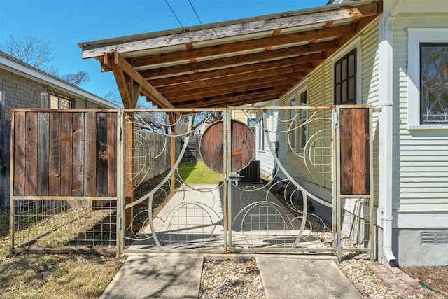 view of gate featuring central AC and an outdoor structure