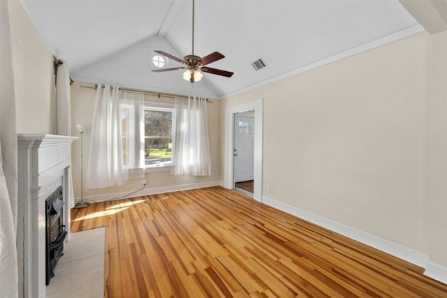 unfurnished living room with lofted ceiling, a fireplace with flush hearth, a ceiling fan, baseboards, and light wood finished floors