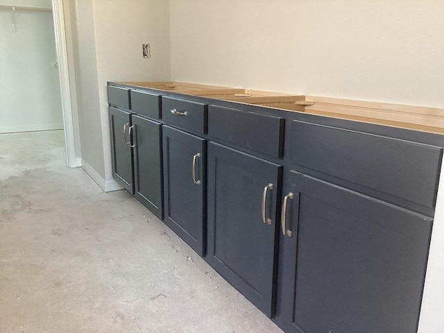 interior details featuring baseboards and concrete flooring