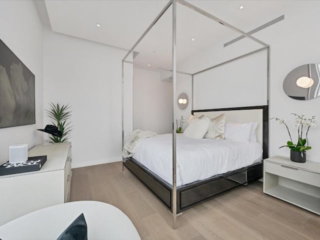 bedroom with light wood-style floors and baseboards