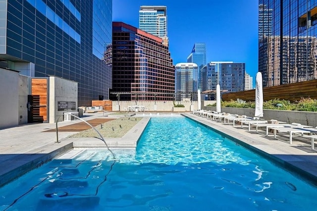 pool featuring a patio area and a view of city