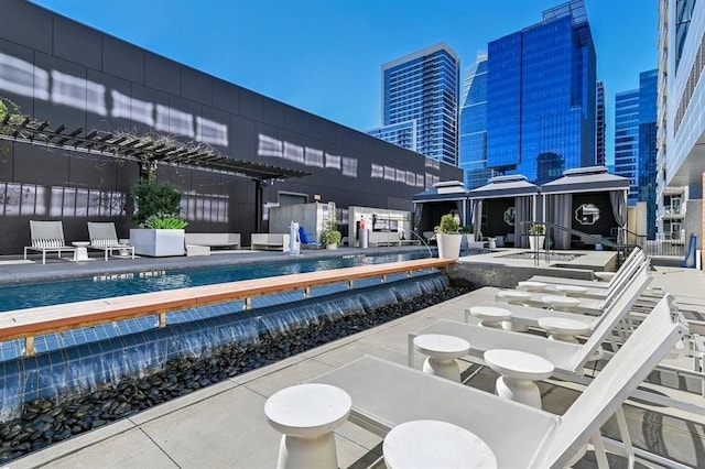 pool with a view of city and a patio area