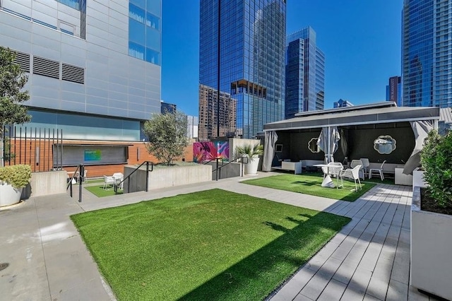 surrounding community with a city view, a yard, and outdoor lounge area