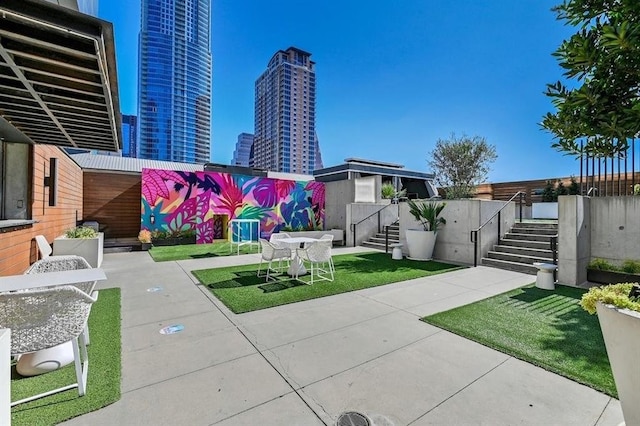 view of patio featuring stairs and a city view