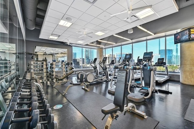 exercise room featuring a paneled ceiling and visible vents