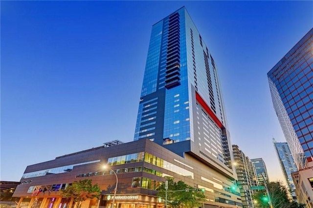 property at dusk with a view of city