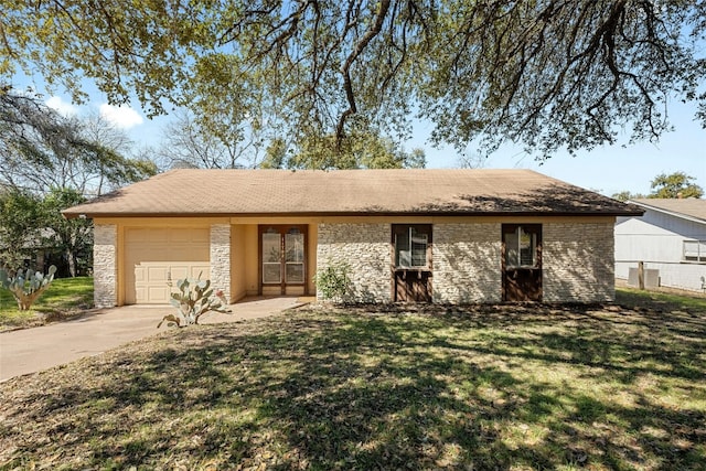 single story home featuring concrete driveway, an attached garage, a front yard, fence, and stone siding