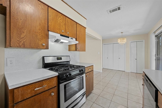 kitchen featuring stainless steel appliances, visible vents, light countertops, and under cabinet range hood