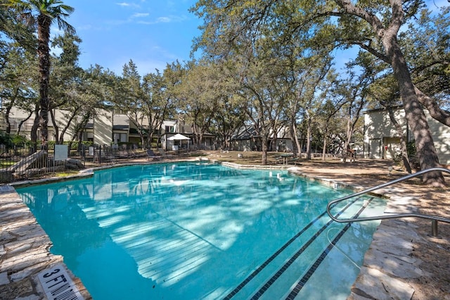 view of pool featuring fence