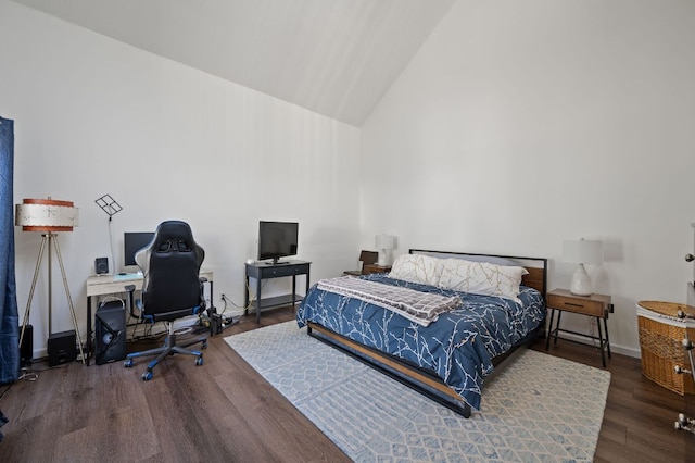 bedroom featuring high vaulted ceiling, wood finished floors, and baseboards