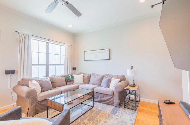 living room featuring recessed lighting, ornamental molding, a ceiling fan, light wood-type flooring, and baseboards