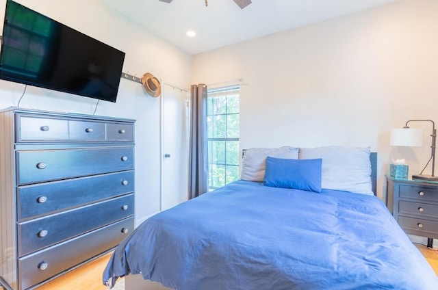 bedroom with light wood-style flooring and a ceiling fan