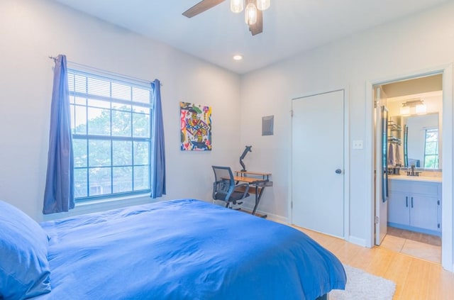 bedroom with connected bathroom, recessed lighting, a sink, a ceiling fan, and light wood-style floors