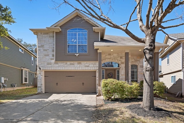 view of front facade featuring driveway, stone siding, and an attached garage