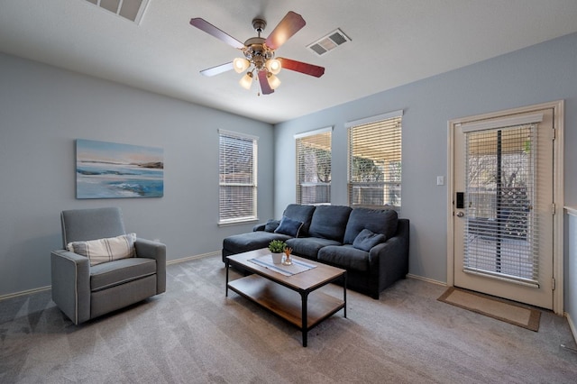 living room featuring carpet floors, a healthy amount of sunlight, and visible vents