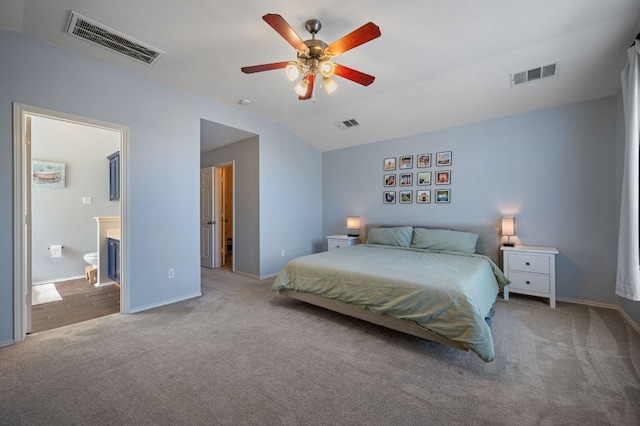 carpeted bedroom with lofted ceiling, visible vents, and baseboards