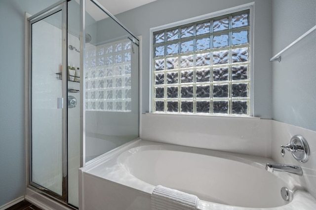 bathroom with a garden tub and a shower stall