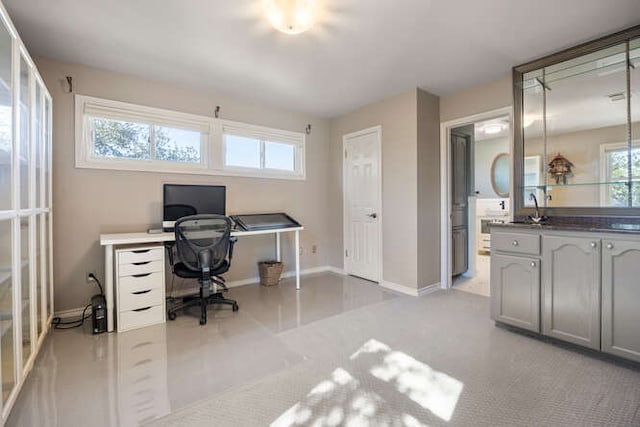 home office featuring a sink and baseboards