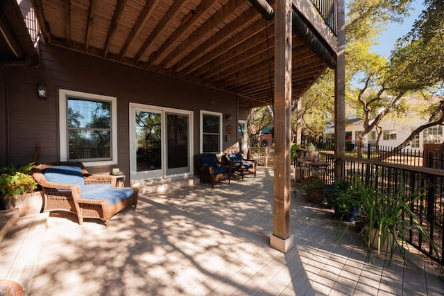 wooden terrace with a patio area and fence