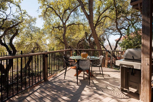 deck featuring grilling area and outdoor dining space